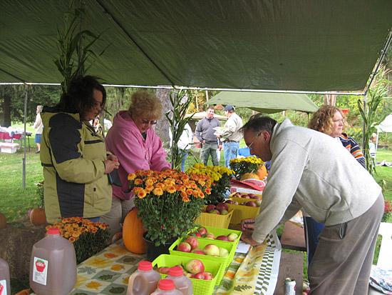 Rotary tent selling mums, apples and apple cider. This photograph is from the 2009 Fall Festival.