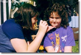 Face painting. This photograph is from the 1999 Fall Festival.