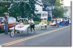 Bed-race teams traveling in the 1999 New Albany Fall Festival parade.