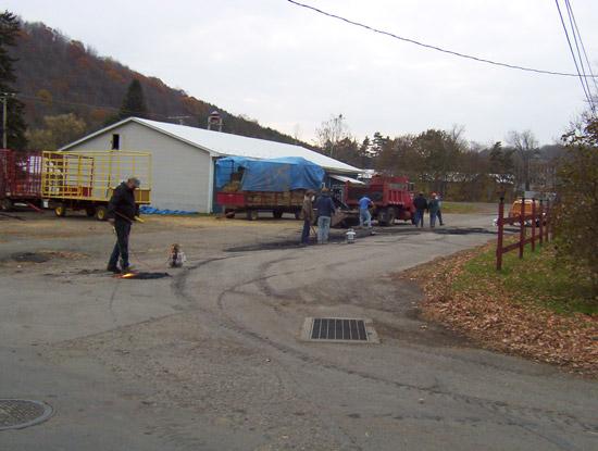 Volunteers fixing pot holes. This photograph is from the Community Volunteers.