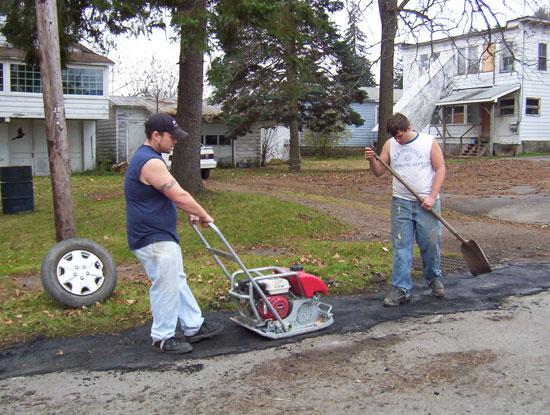 Volunteers fixing pot holes. This photograph is from the Community Volunteers.